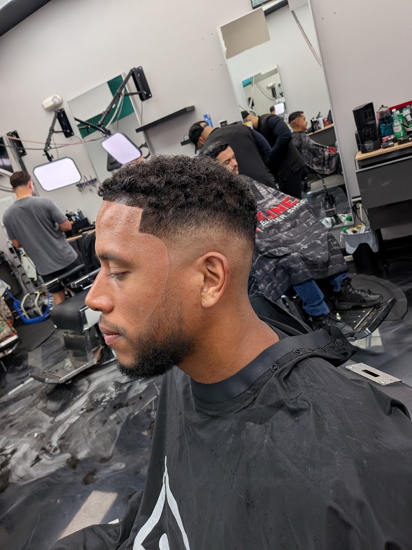 Curly taper fade with sharp part, cut by The Head Sculptor